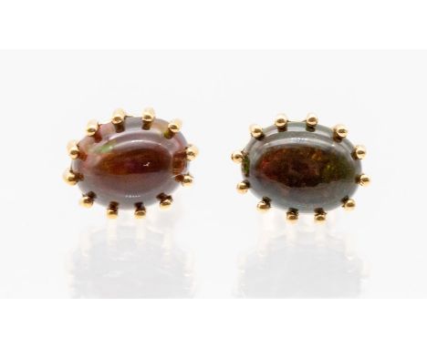 A pair of midnight opal and 9ct gold earrings, comprising oval opals claw set, total stone weight approx. 2.46 carats, on pos