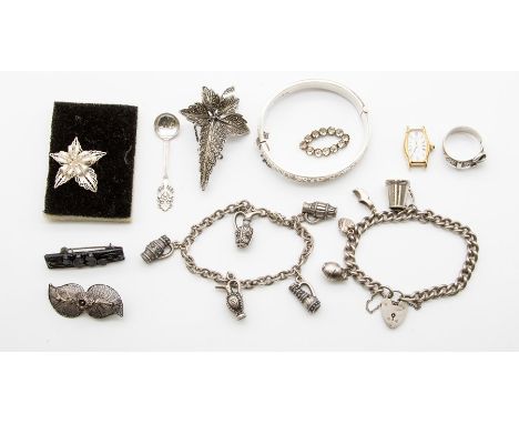 A collection of silver and white metal&nbsp; jewellery to include: a silver bangle with engraved details hinged, a silver buc