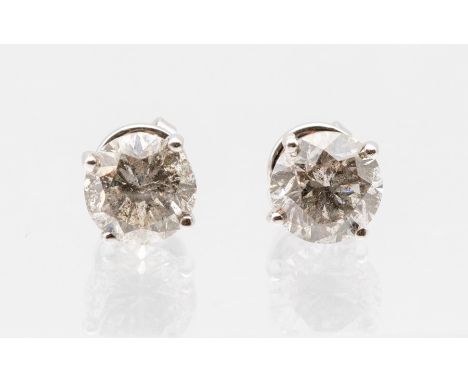 A pair of diamond and 18ct white gold solitaire earrings, comprising claw set round brilliant cut diamonds, weighing a total 