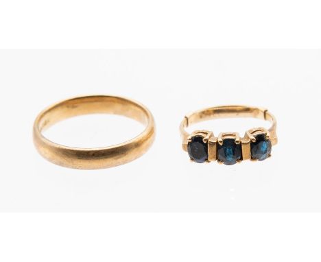 A sapphire three stone 9ct gold ring, comprising three oval cut sapphires bar set, sizeJ1/2,  along with a 9ct gold 4mm court