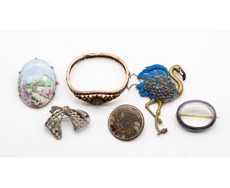 A collection of five Brooches including an Amonite brooch set in&nbsp;silver, a Hollywood paste set flamingo brooch with&nbsp