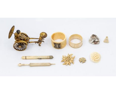 A collection of bone items including brooches, parasol miniature, propelling pencil, two napkin rings and Buddah pendant; alo