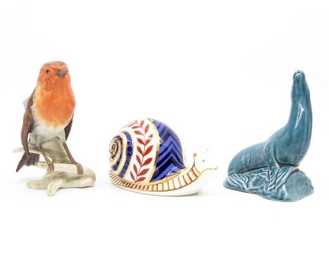 A Royal Crown Derby gold stopper paperweight of a snail, a Goebel Robin and Poole Pottery sea lion