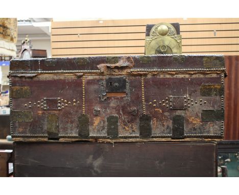 A late 19th Century leather covered and brass bound travelling trunk, studded, bearing original makers label inside for James