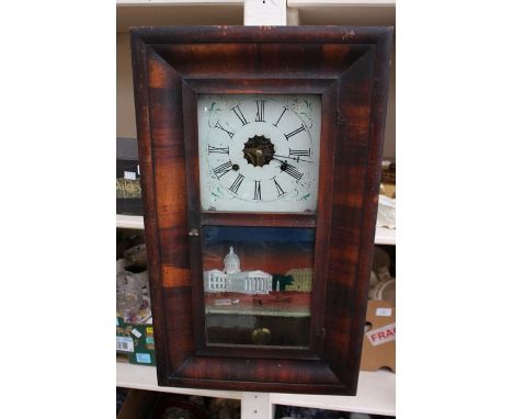 A late 19th Century American mahogany wall clock, made by E.N. Welch, having two winder holes, measuring 66cm high, 39cm wide