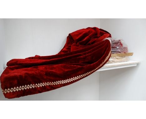 A pair of early 20th Century red velvet full length curtains, with brocade style piping to edges, blanket lined, one curtain 