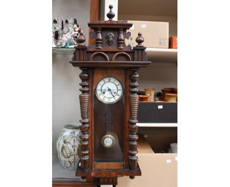 A late 19th Century walnut veneered Vienna wall clock, applied split turned columns to case, pediment to top, 103cm high, 38c