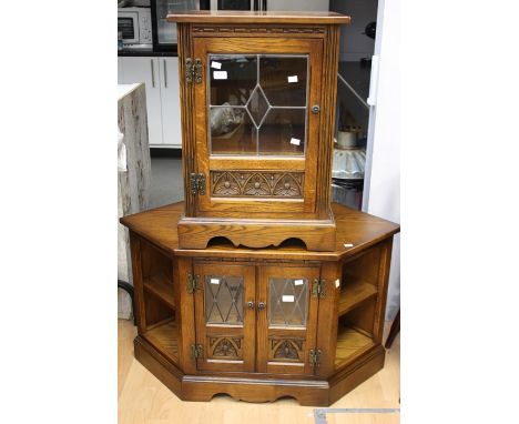 An oak single door cabinet and a matching TV stand, a folding oak cake stand, a marquetry firescreen and a brass large sized 