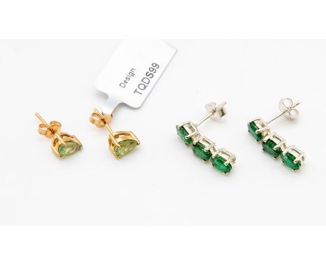 A pair of Russian demantoid garnet and 9ct gold stud earrings, comprising pear cut claw set stones weighing approx. 1.24 cara