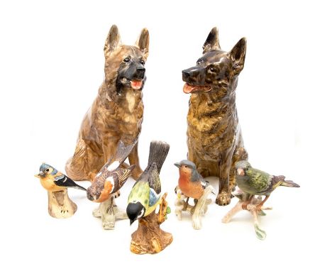 Two painted earthenware models of Alsatians / German Shepherds, one signed KR to base together with five various birds, finch