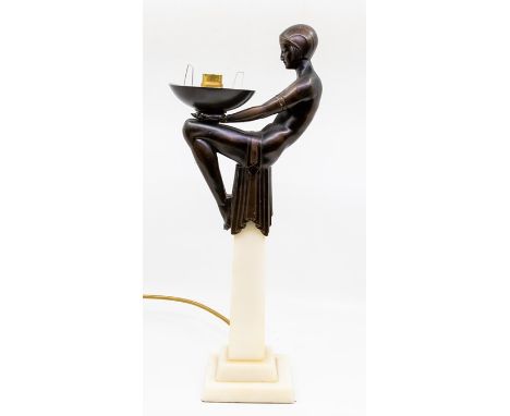 A modern Art Deco style bronzed and marble table lamp, the top modelled as seated lady holding a bowl (electrified)&nbsp;