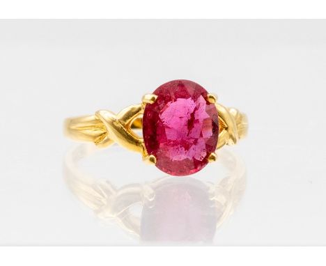 A ruby and 9ct gold ring, the claw oval ruby weighing approx 2.7carats, to open cross over shoulders, size O, total gross wei