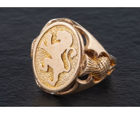 A 9ct gold signet ring depicting the lion rampant of Scotland,: openwork thistles to shoulders, with hallmarks for Birmingham