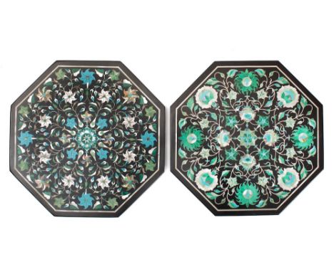A black marble octagonal panel: inlaid with malachite, mother-of-pearl and enamel floral decoration, 25.5cm wide, together wi