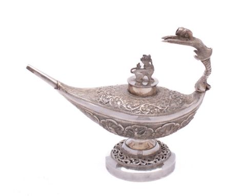 A Burmese silver pedestal oil lamp: of oval outline, the circular pull-off lid with temple dragon finial, the handle in the f