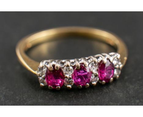 An 18ct gold pink sapphire and round, brilliant-cut diamond ring,: total estimated diamond weight ca. 0.15ct, calculated tota