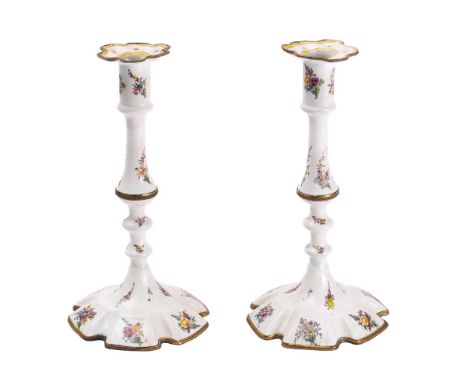 A pair of 19th century South Staffordshire enamel candlesticks: the cylindrical sconces with petal-shaped drip trays, raised 
