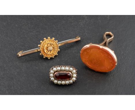 Two brooches and a seal fob,: including an Etruscan revival style brooch, stamped '9C', length ca. 3.9cm;  a carnelian seal f