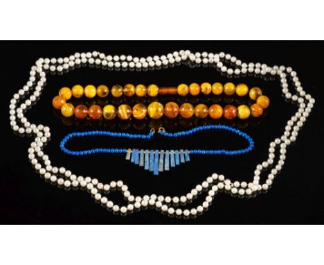 A lapis lazuli bead necklace,: the central fringe of polished lapis lazuli batons with spacers in between, to lapis lazuli be