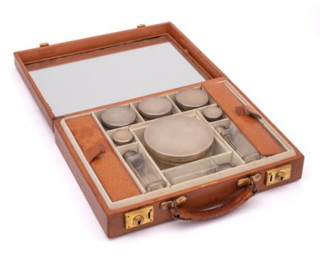 For Asprey &amp; Co, London,  A lady's light brown Morocco leather  travelling vanity case: containing nine clear glass and s