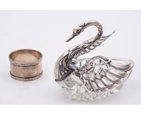 A clear glass and silver mounted table salt, bears import marks for London, 1967: in the form of a swan with hinged wings, 11