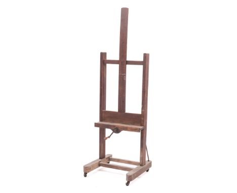 A Victorian oak studio easel, late 19th century,: the picture shelf with bevel gear height adjustment and winding handle; the