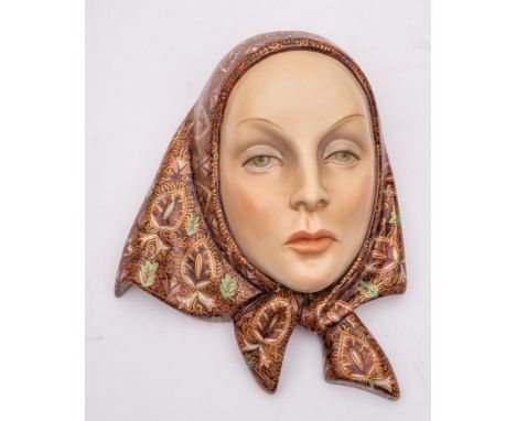 A Lenci pottery wall mask: modelled by Helen Konig Scavini as a young woman wearing a brightly decorated head scarf, painted 