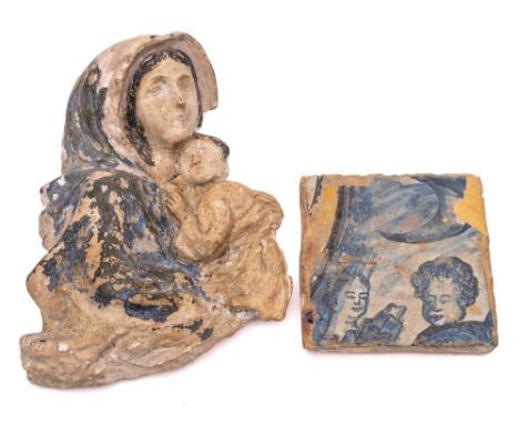 A maiolica tile: of square form painted in blue with two heads, probably 16/17th century, together with a cast fragment of th