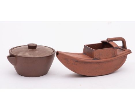 A Chinese Yixing 'boat' teapot and a similar small handleless teapot/jug and cover: the first in the form of a canal boat wit