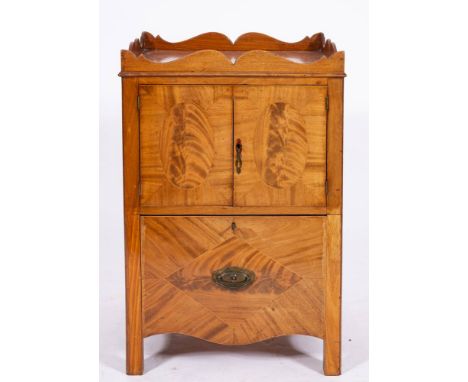 A George III mahogany night commode, circa 1775,: the tray top with serpentine edging; the front with twin doors with oval re