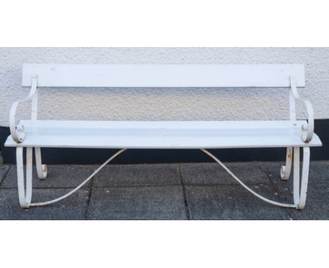 A painted wood and wrought iron garden seat, circa 1900,: the single plank back and slatted seat with scrolling armrests and 