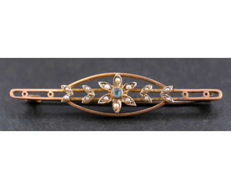 An openwork, seed pearl and blue topaz brooch with stylised floral decoration,: stamped '9ct' length ca. 5.6cm, total weight 