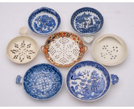 A group of seven late 18th/early 19th century English pottery and porcelain egg strainers: comprising a Caughley blue and whi