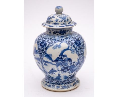 A Chinese blue and white baluster jar and cover: painted with four lotus-shaped panels depicting presentation scenes on a scr