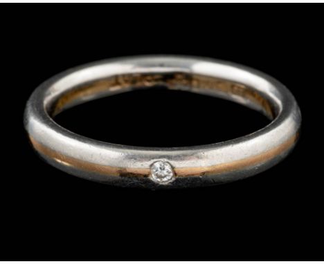 An 18 carat gold and platinum diamond ring,: the brilliant cut diamond set into the polished band, stamped 750 with London ha