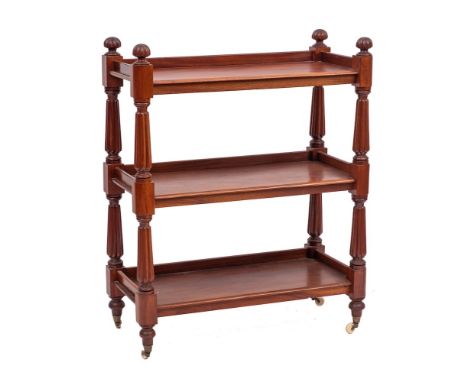 A William IV mahogany three tier buffet, circa 1835,: the shelves all with three-quarter galleries, with lobed finials at the
