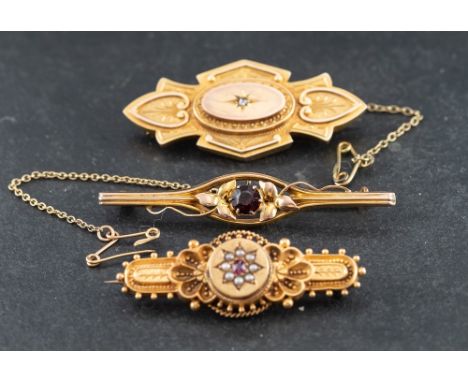 Three brooches,: including a Victorian, 15ct gold, ruby and seed pearl brooch, with hallmarks for Birmingham, length ca. 4.3c