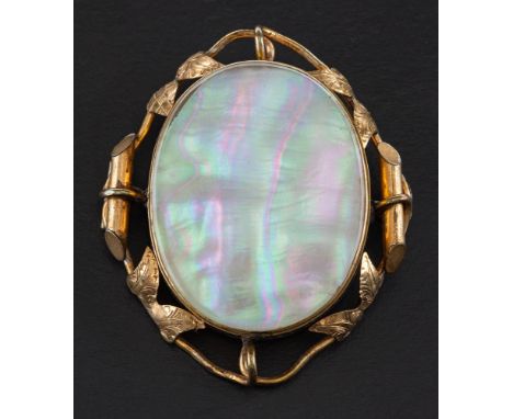 Two oval, gilt metal pendant/ brooches,: a shell cameo pendant/ brooch depicting figures in a classical landscape with engrav