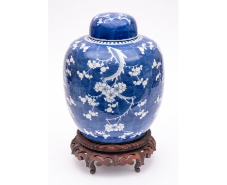 A Chinese porcelain jar and cover: of oviform with domed cover, painted in blue with prunus, apocryphal six character mark fo