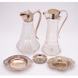 An electro-plated three-piece teaset: a clear glass and plate mounted claret jug,