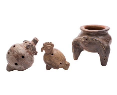 A Mexican Pre-Columbrian pottery whistle, one similar and a tripod vessel: the two whistles or flutes in the form of 'ocarina
