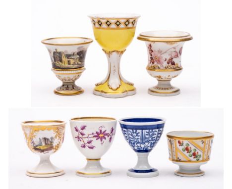 A group of seven egg cups: including a campana-shaped  cup painted with a rustic landscape, circa 1820; one similar painted w