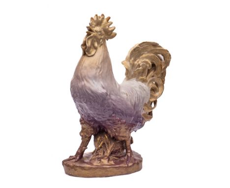 A large Continental porcelain figure: of a crowing cockerel on an oval rustic base, under shot enamel colours, late 19th cent