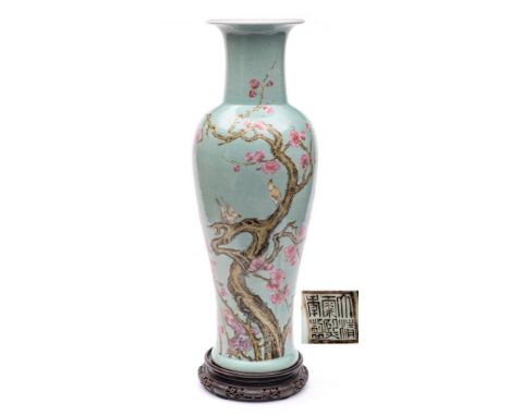 A large Chinese famille rose baluster vase: finely enamelled with four birds perched on a gnarled blossoming prunus tree on a