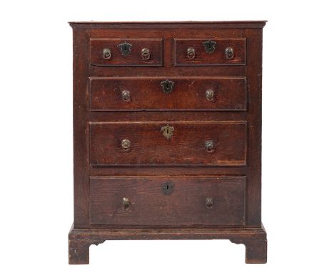 An early George III oak chest of drawers, circa 1765,: the cleated top with moulded edges, above two short and three graduate
