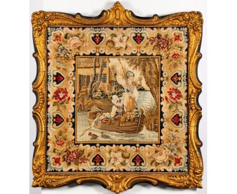 A 19th century gilt framed woolwork tapestry: depicting a women and a young boy in a rowing boat, enclosed by a Berlin work s