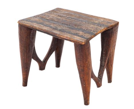An African carved hardwood stool or low table, Nupe Tribe, central Nigeria, first half 20th century,: modelled from a single 