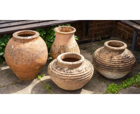 A group of four terracotta garden pots, 20th century,: the largest of ovoid form, 52cm high* The property of the Late Ann Mey