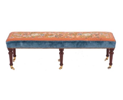 A tapestrywork upholstered long stool in 19th century style,: the rectangular seat depicting flowers and foliage on a peach g