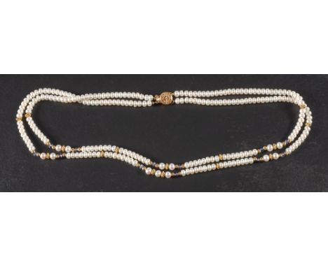 A two row cultured pearl necklace with sapphire spacers,: the pearls of button form and creamy hue with pink overtones, diame